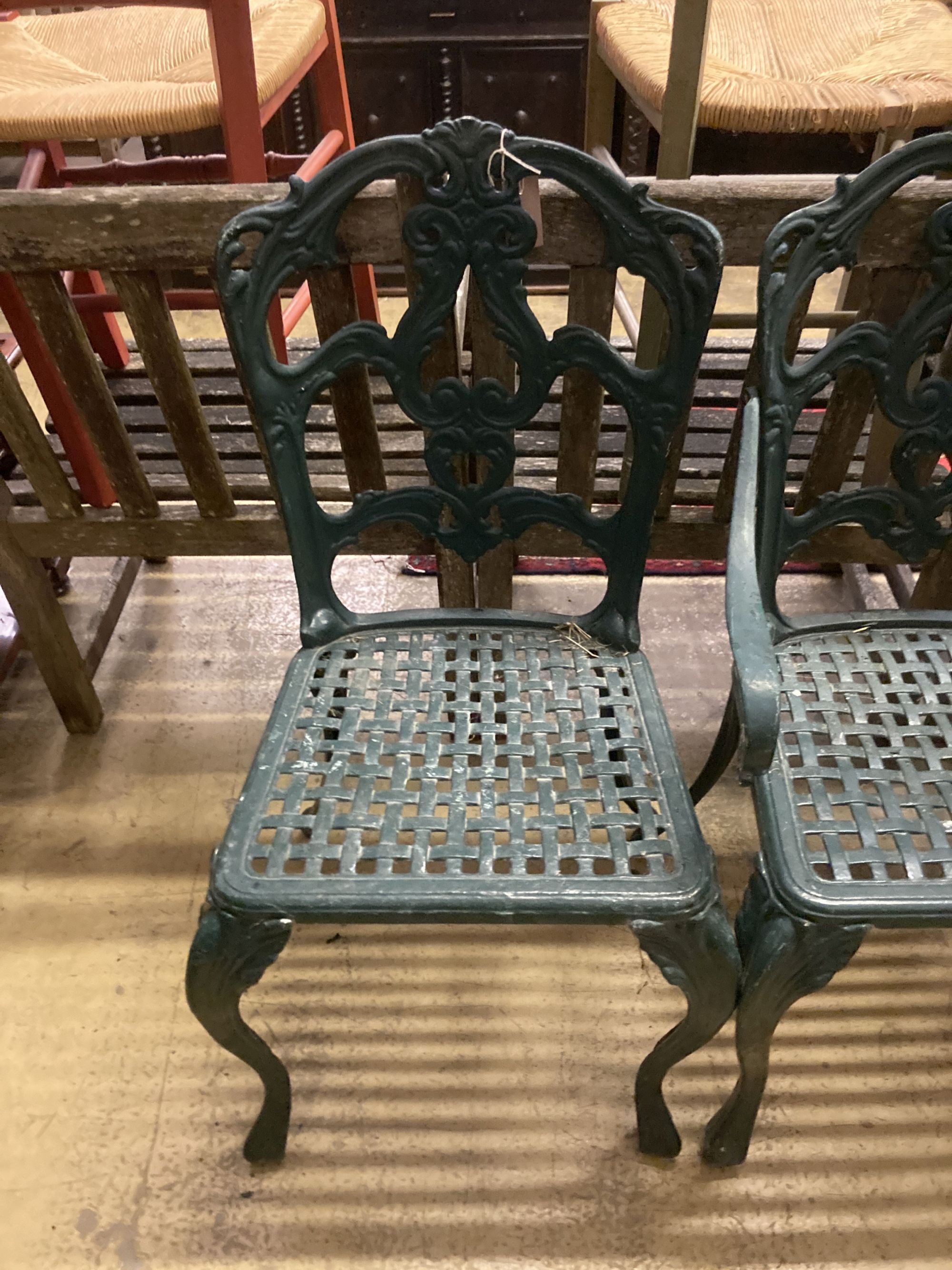 A set of four painted cast aluminium garden chairs (two with arms)